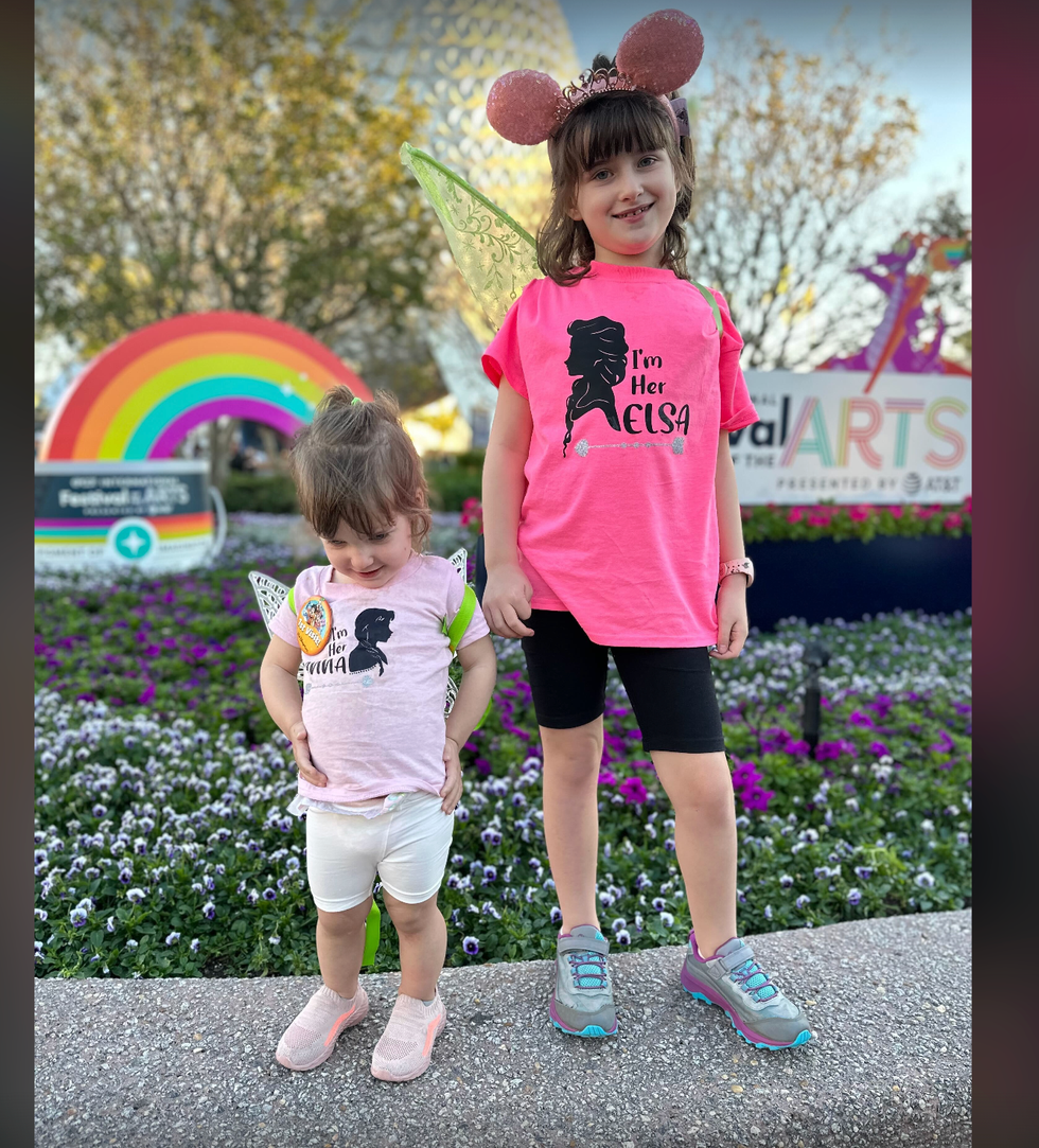 siblings stand next to each other in disney world, wearing walking shoes that can withstand a day in the parks