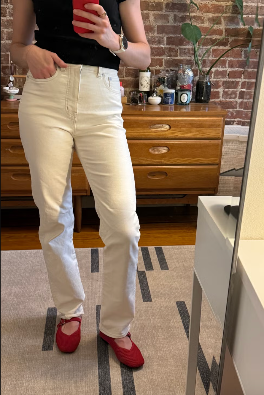 a person modeling white jeans from madewell in a bedroom