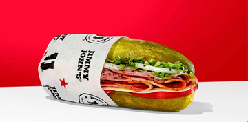 a sandwich wrapped in paper with the jimmy johns logo resembling a large pickle