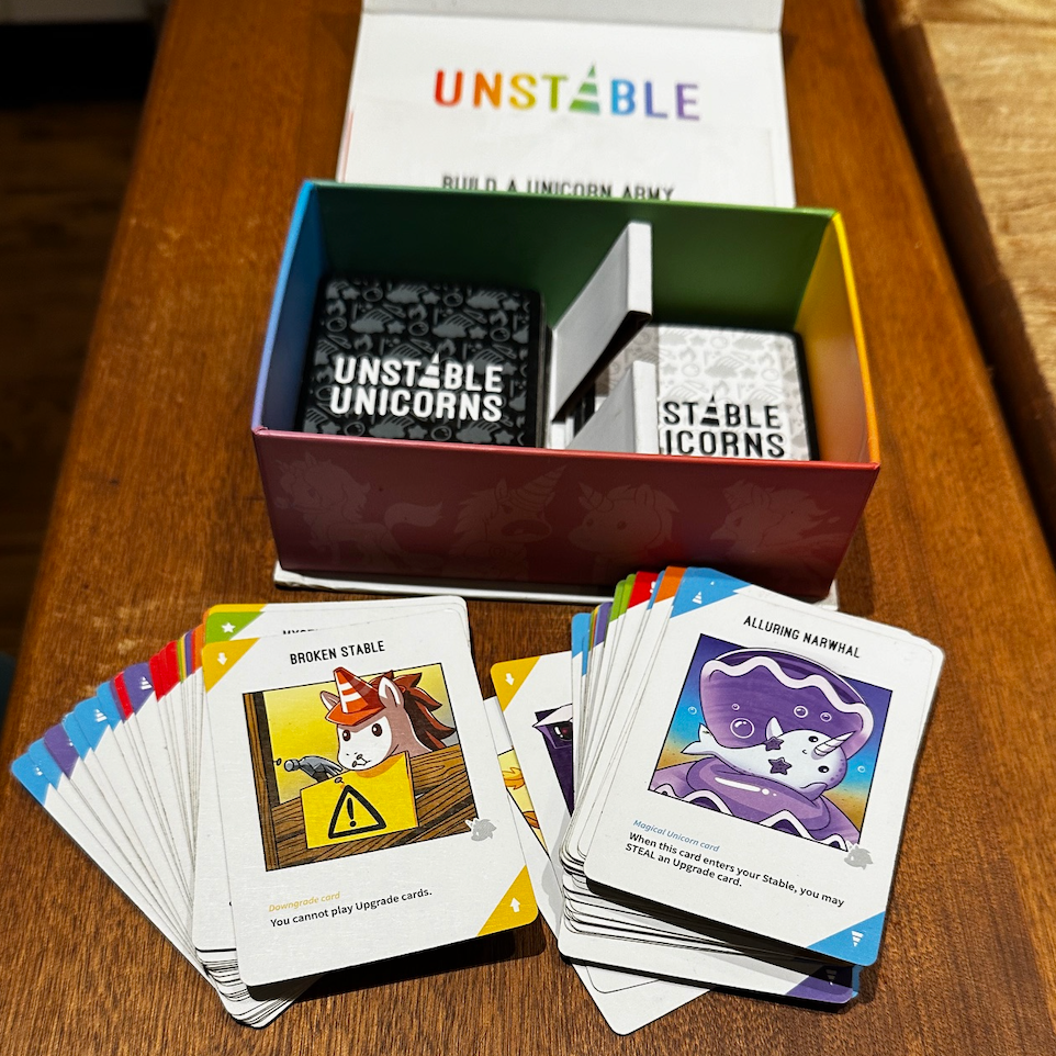 unstable unicorns, one of the best card games for every age box and cards for the card game unstable unicorns