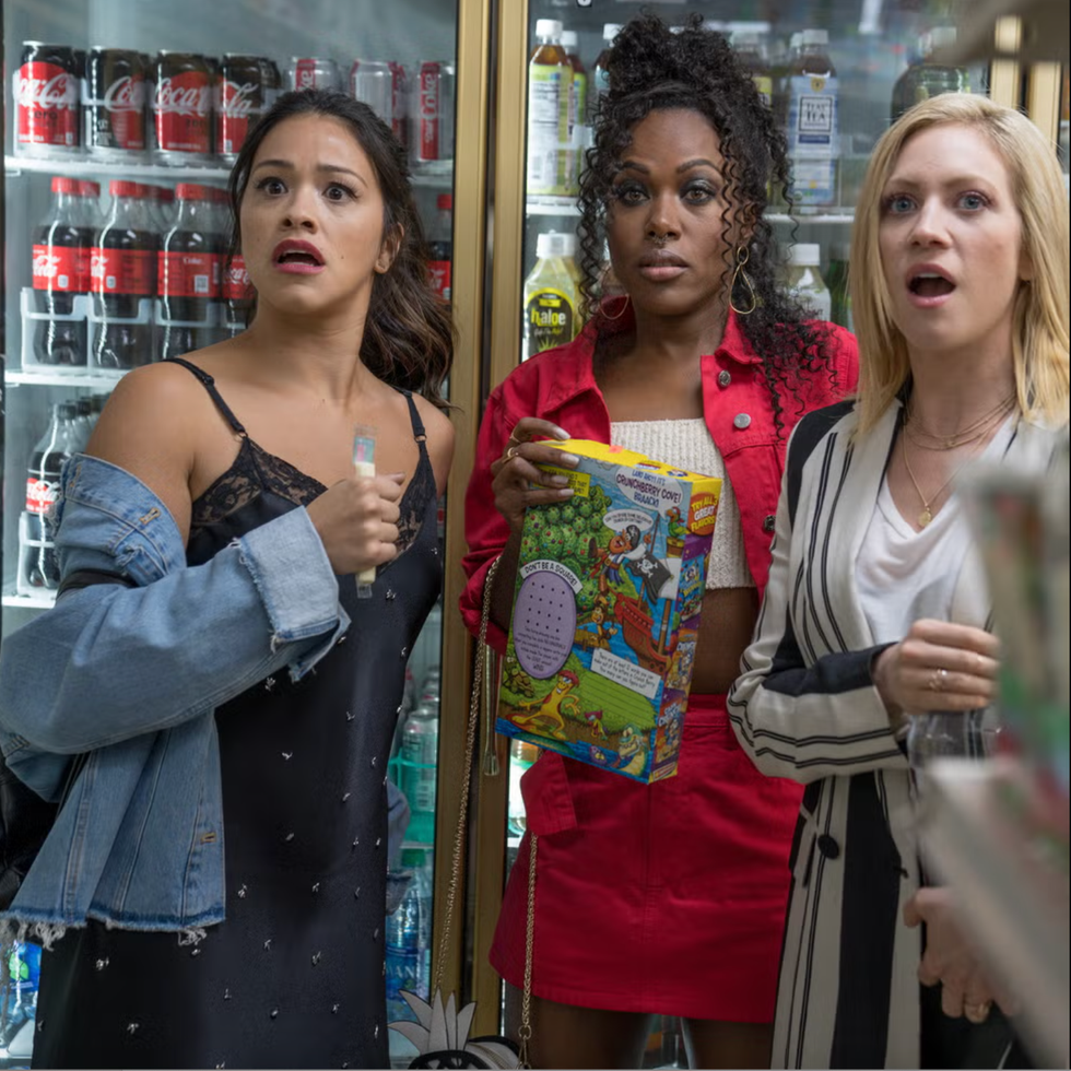 group of three individuals in a convenience store near a refrigerated section group of three individuals in a convenience store near a refrigerated section