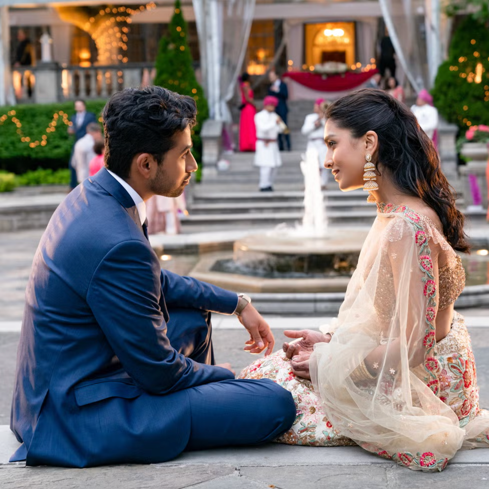 a couple seated near a fountain in a garden setting engaging in conversation a couple seated near a fountain in a garden setting engaging in conversation