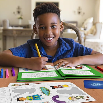 child engaged in a coloring activity with books and markers on a table child engaged in a coloring activity with books and markers on a table
