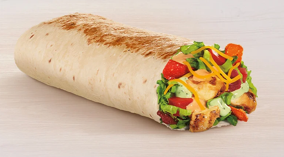 a wrapped tortilla filled with grilled chicken lettuce tomatoes cheese and sauce