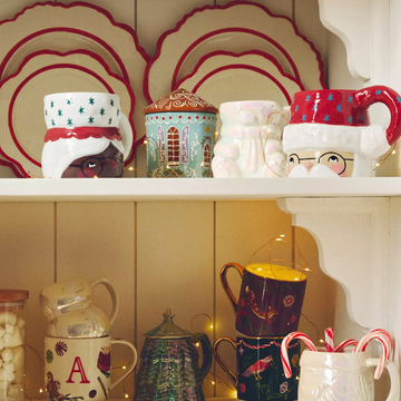 anthropologie holiday glasses a collection of colorful mugs and decorations on a shelf