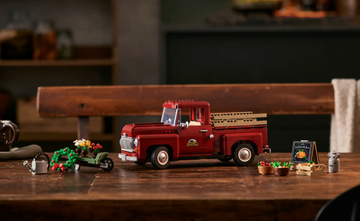 a lego set featuring a vintage truck with farming accessories