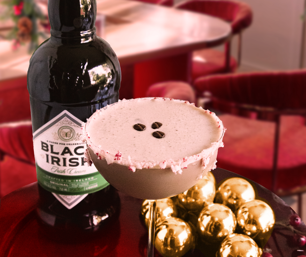 cocktail in glass with festive decoration and a bottle of Irish cream