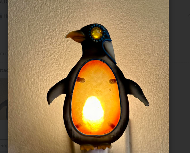penguin shaped night light with a glowing interior