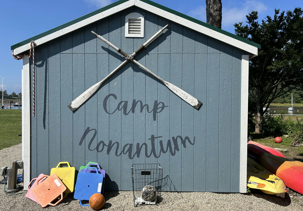 building wall with camp name and sports equipment