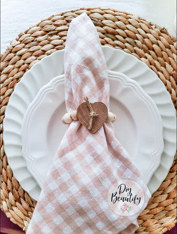 napkin arranged on a plate with a heart ring