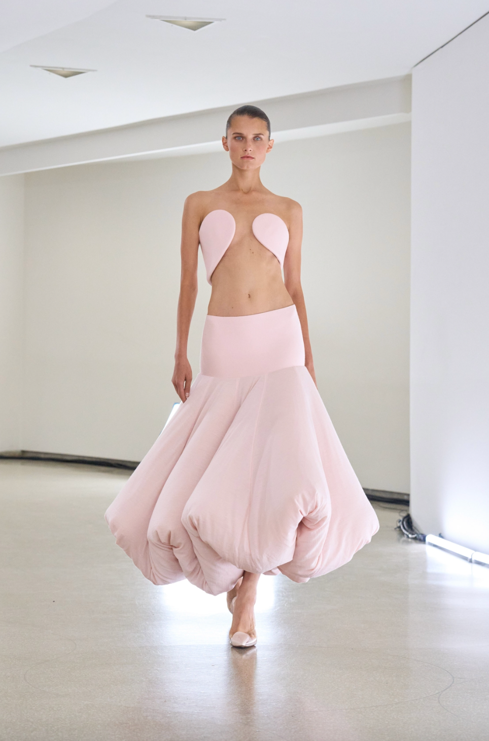 Runway model wearing a balloon-like pink dress