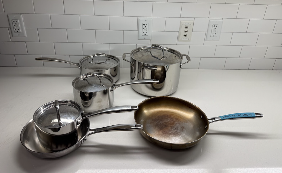 stainless steel cookware set arranged on a countertop