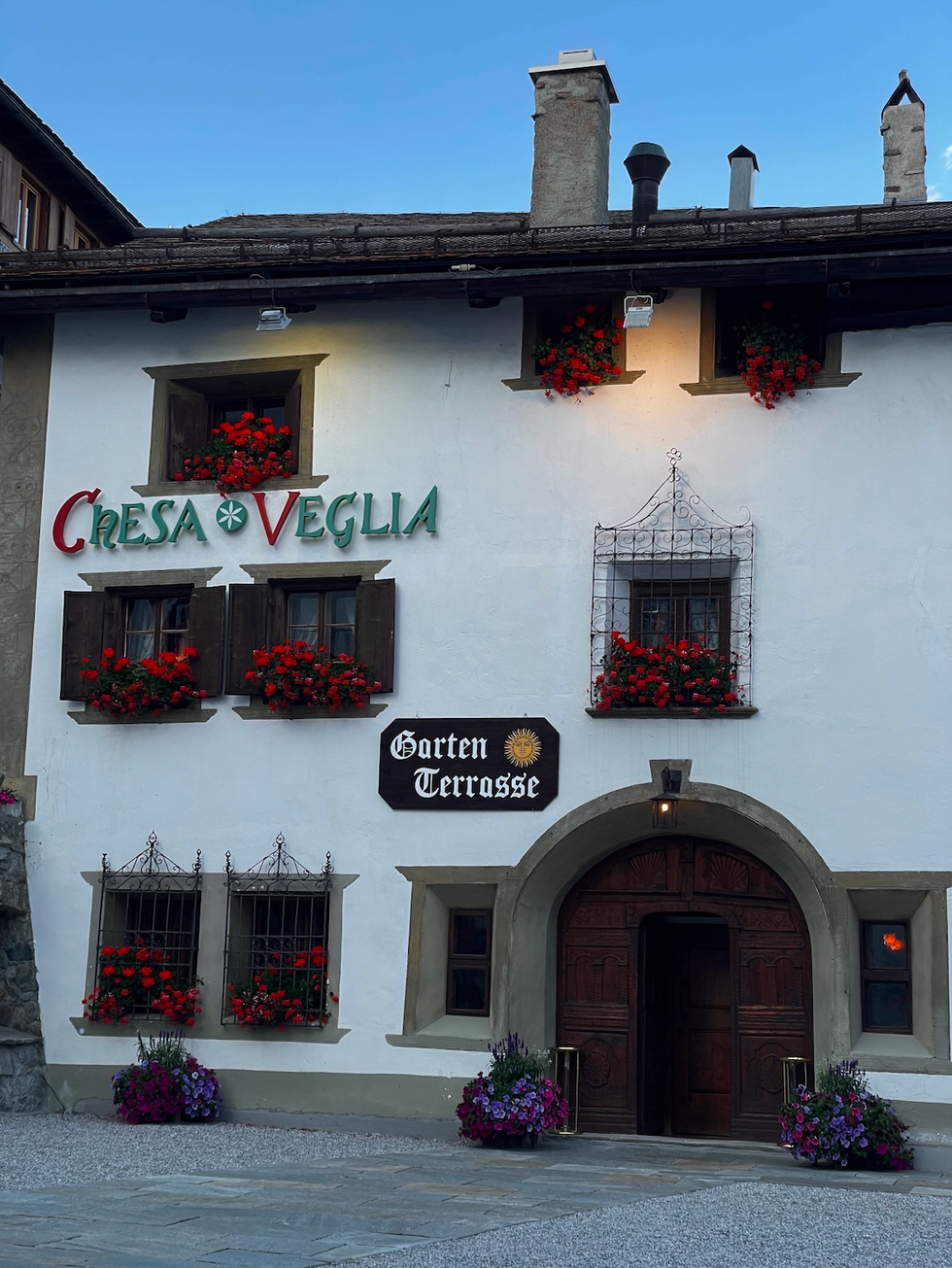 building with a rustic facade prominent signage and flower decorations