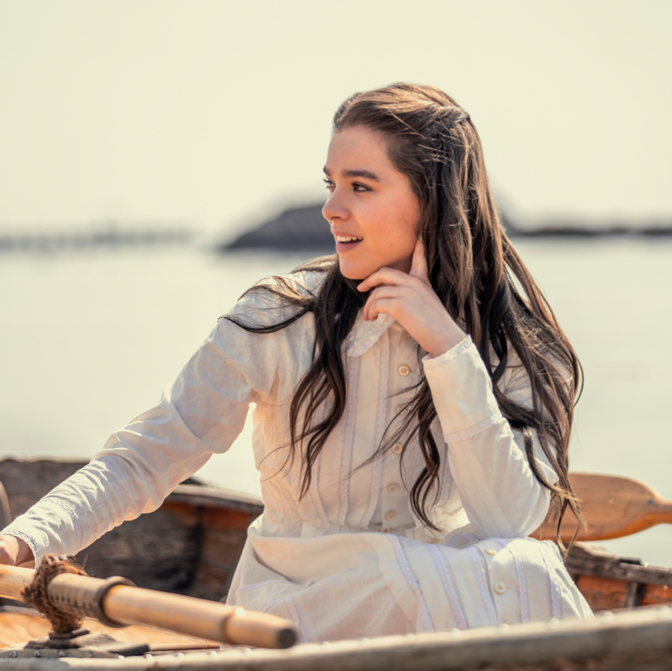 Dickinson Episode Still a person sitting in a boat holding a paddle and resting their chin on their hand