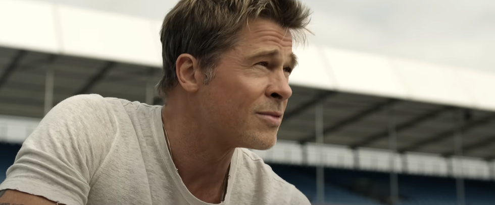 a person is seated engaged in conversation possibly at a sports facility