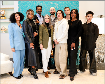 group of individuals posing together in a stylish indoor setting