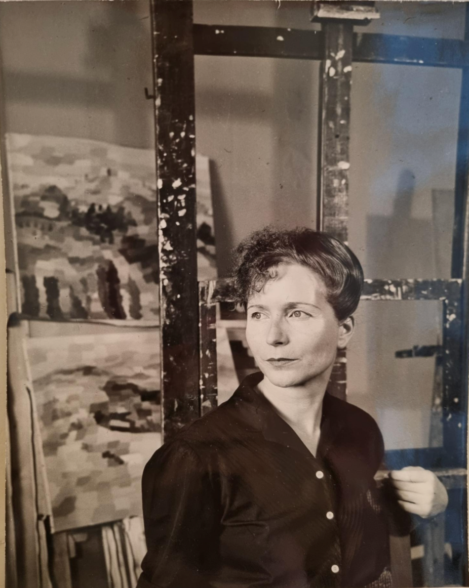 a figure in front of an easel with abstract art in the background