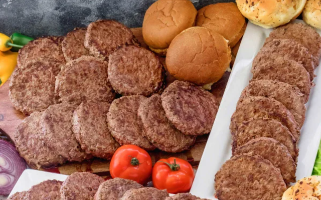 assortment of burger patties buns and fresh vegetables