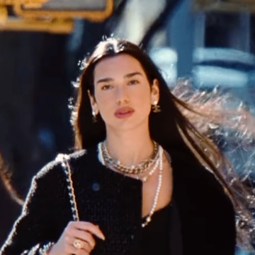 Dua Lipa Chanel Campaign fashionable individual walking on a city street