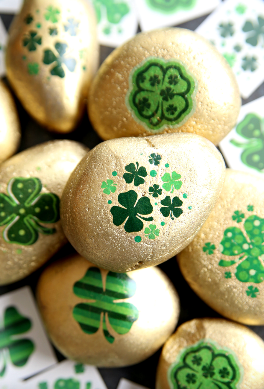 decorative golden stones with green clover designs
