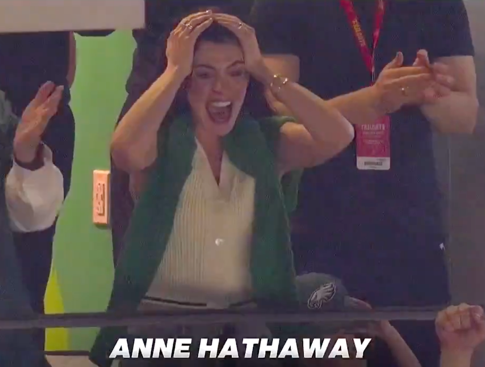 crowd reaction during an event with a focus on an individual expressing excitement