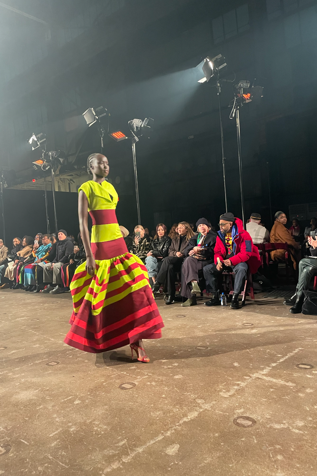 model showcased in a vibrant striped dress during a fashion show christopher john rogers nyfw model showcased in a vibrant striped dress during a fashion show christopher john rogers nyfw