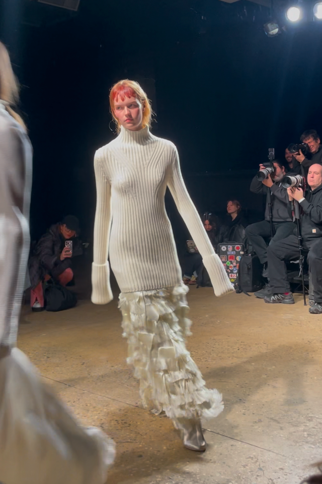 fashion model walking on runway showcasing a stylish outfit fashion model walking on runway showcasing a stylish outfit