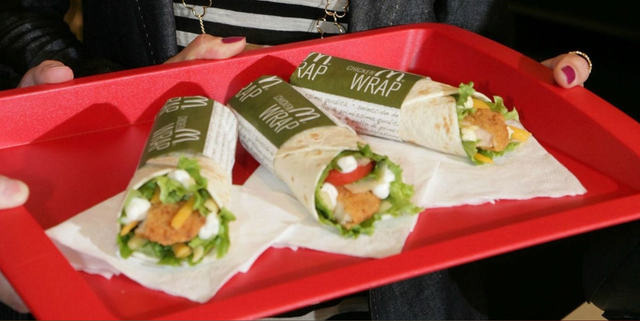 tray holding three chicken wraps with fresh ingredients