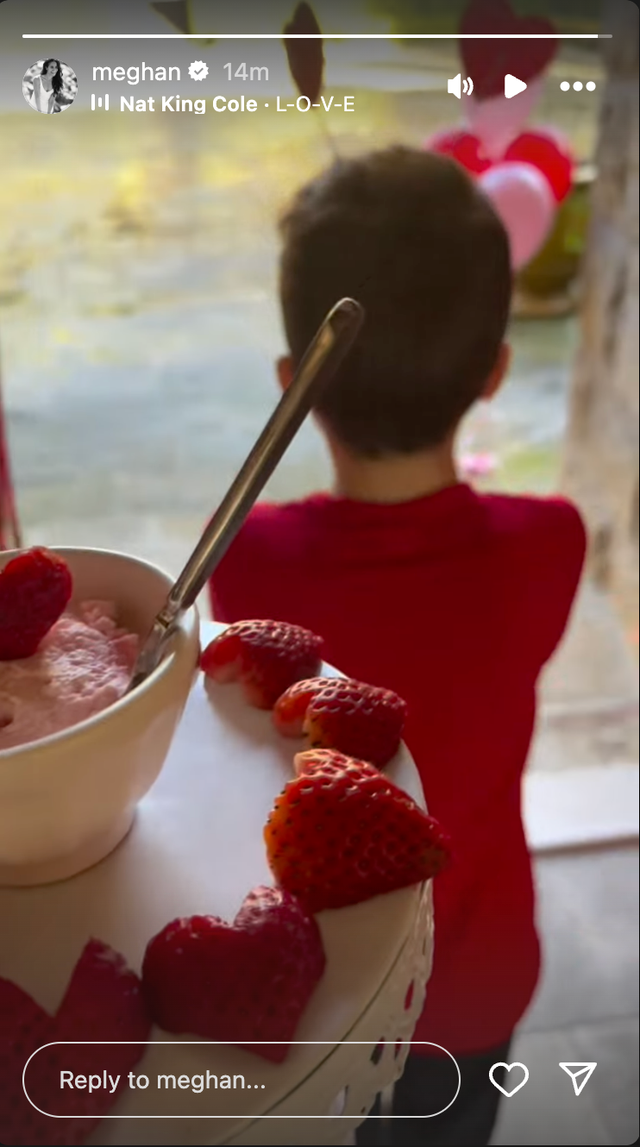 child looking at a festive setup with dessert and strawberries