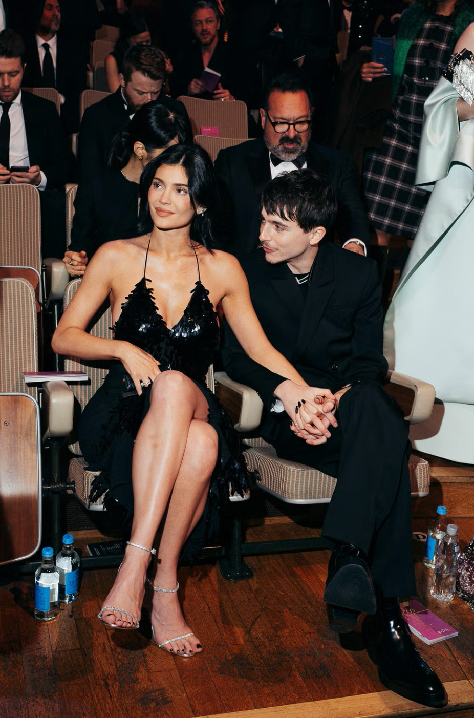couple seated together at an event engaged and dressed formally