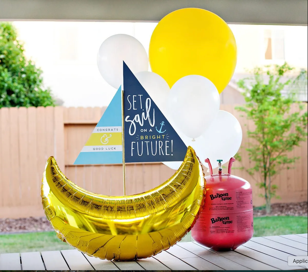 celebratory decoration featuring balloons and a themed flag