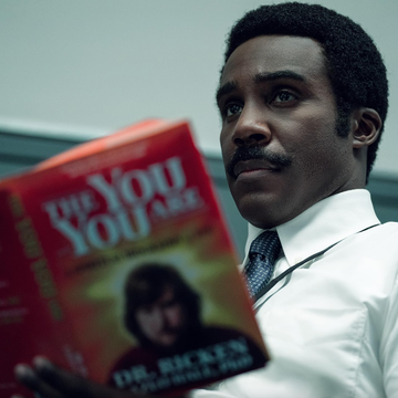mr. milchick holding a book mr. milchick holding a book