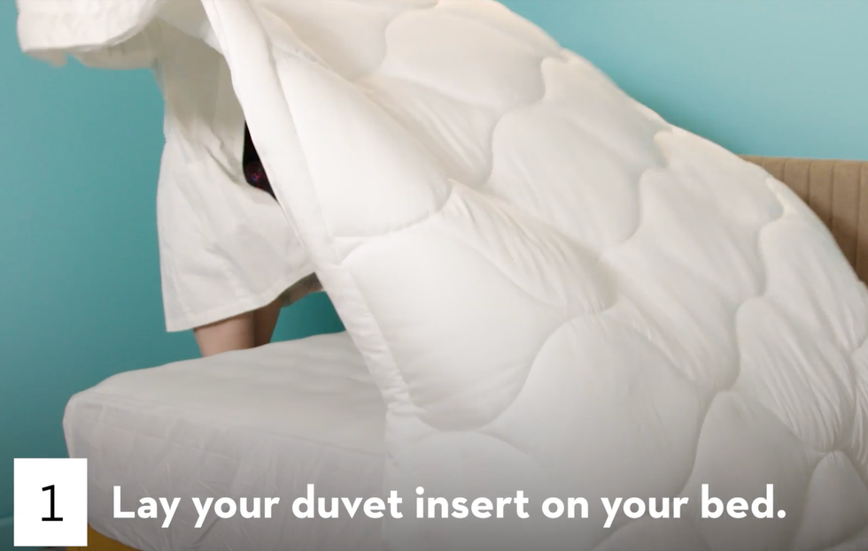 laying duvet cover on bed