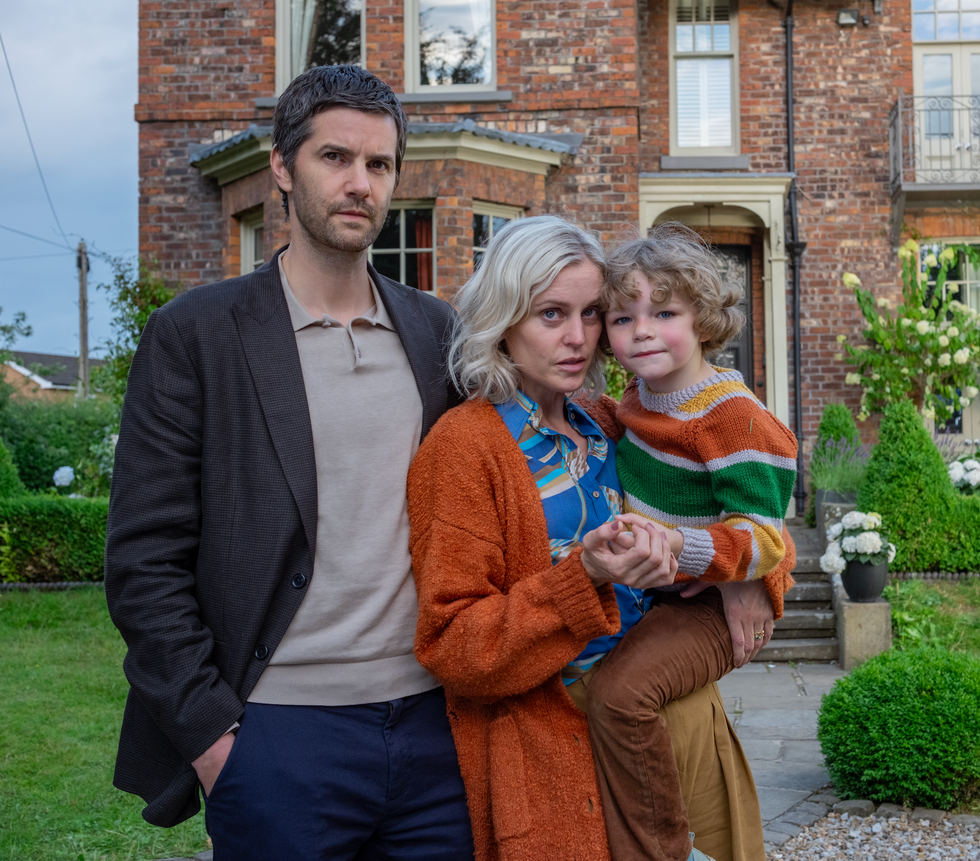 a family portrait in front of a house