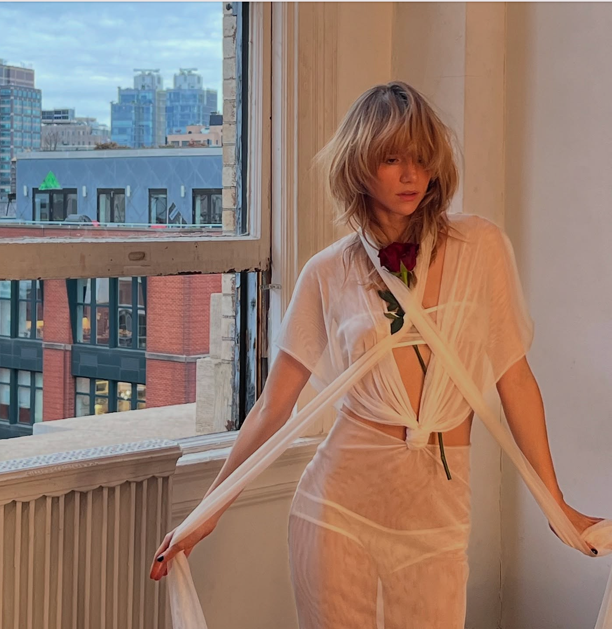 Suki Waterhouse Wears an All-White Sheer Dress with Tiny Undergarments