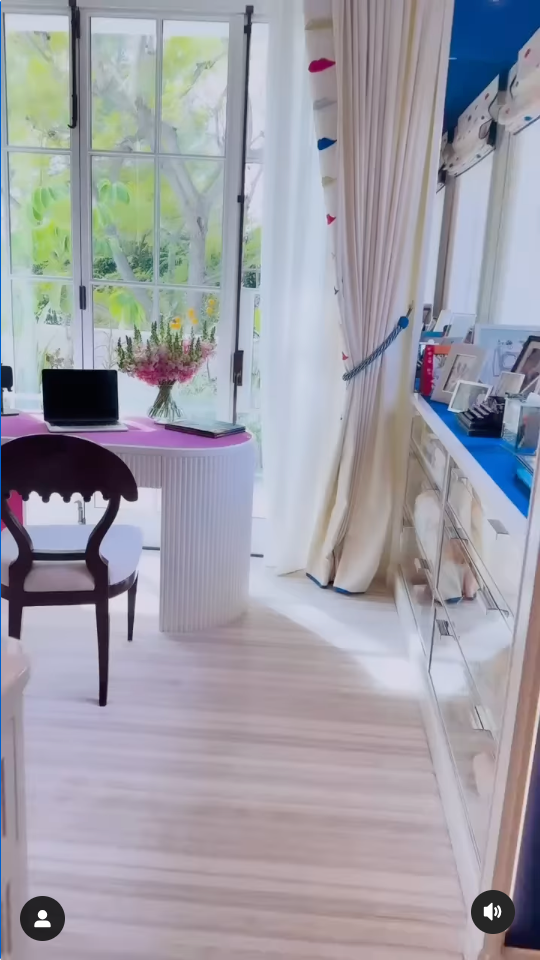 a welllit home office with a modern desk and chair featuring a laptop and decorative elements