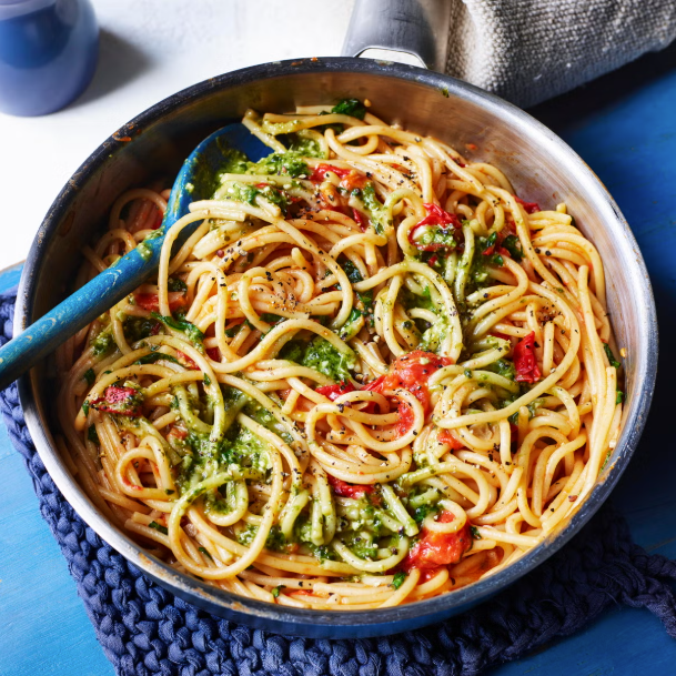 plate of spaghetti with pesto and cherry tomatoes