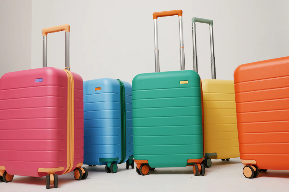 five kids' carry on luggage suitcases in pink, blue, green, yellow and orange