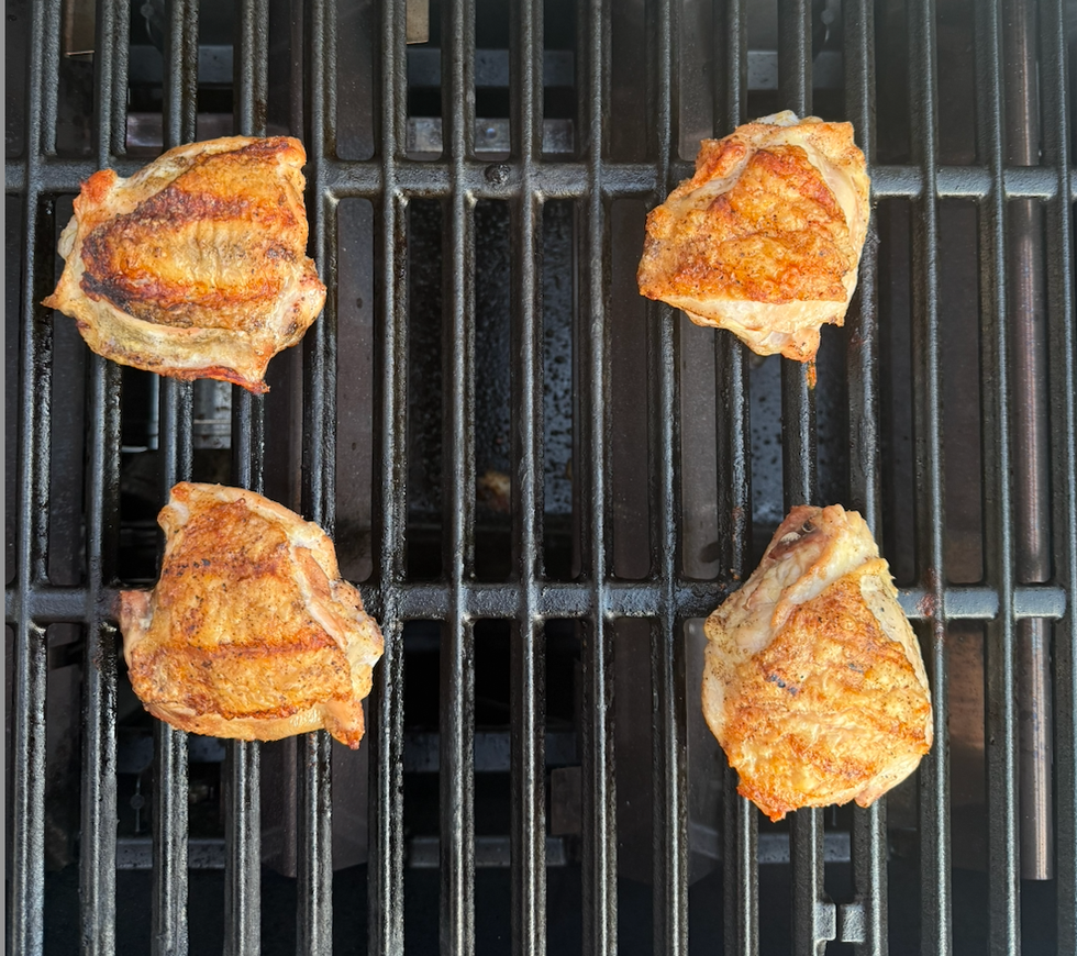 chicken thighs on a grill