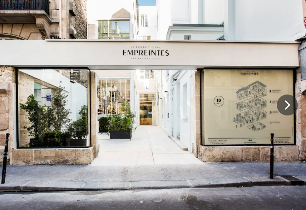 entrance to a concept store named empreintes showcasing a modern retail space with large windows and a clear signage