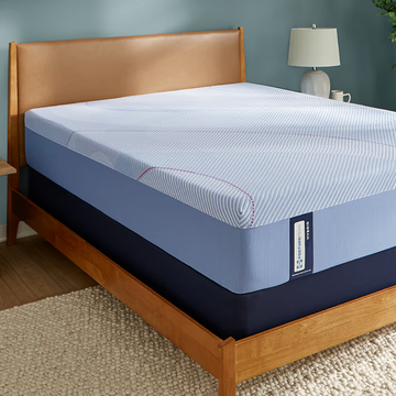 Good Housekeeping review of Sealy Posturepedic Hybrid mattress sealy posturepedic hybrid mattress on a wood bedframe in a bedroom