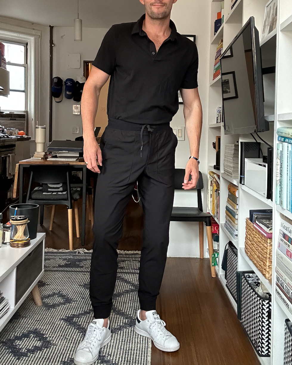 a person in casual attire stands in a modern living space