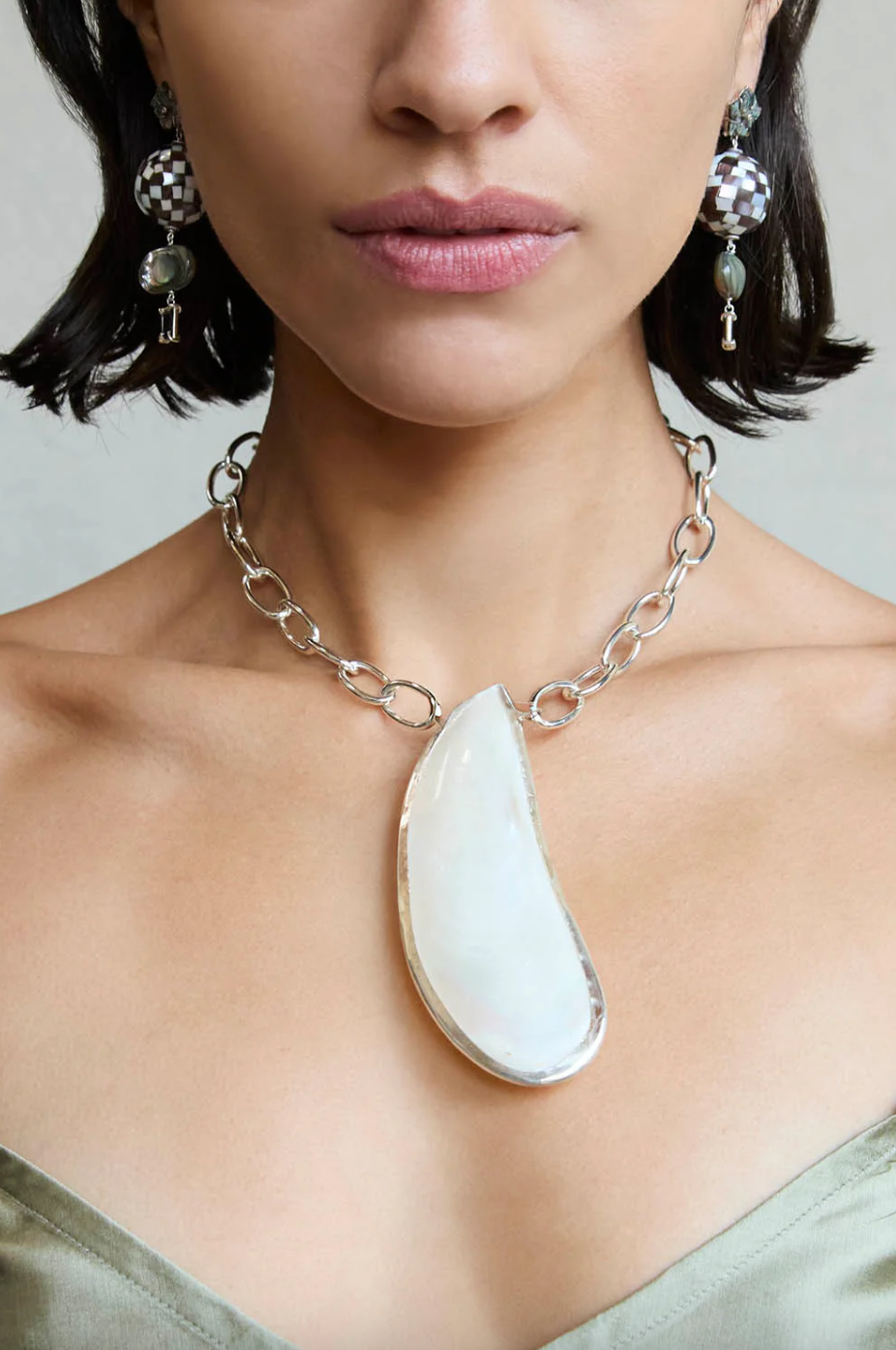 woman wearing mussel charm necklace
