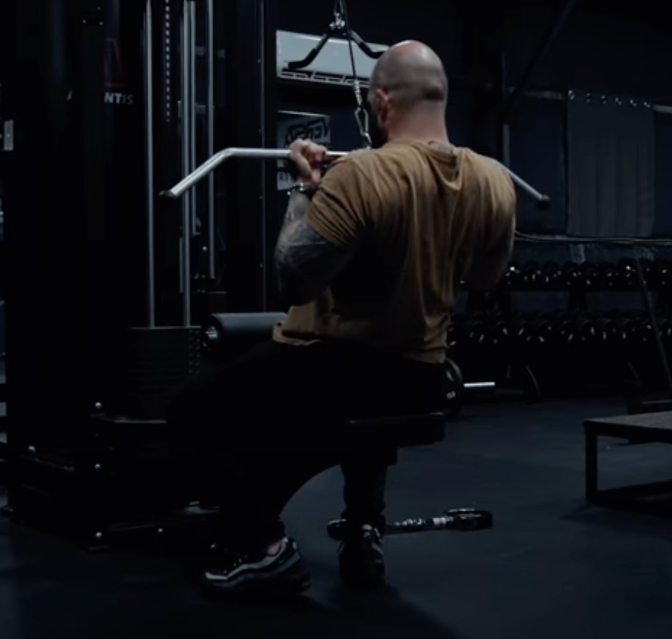 individual performing seated cable rows in a gym setting