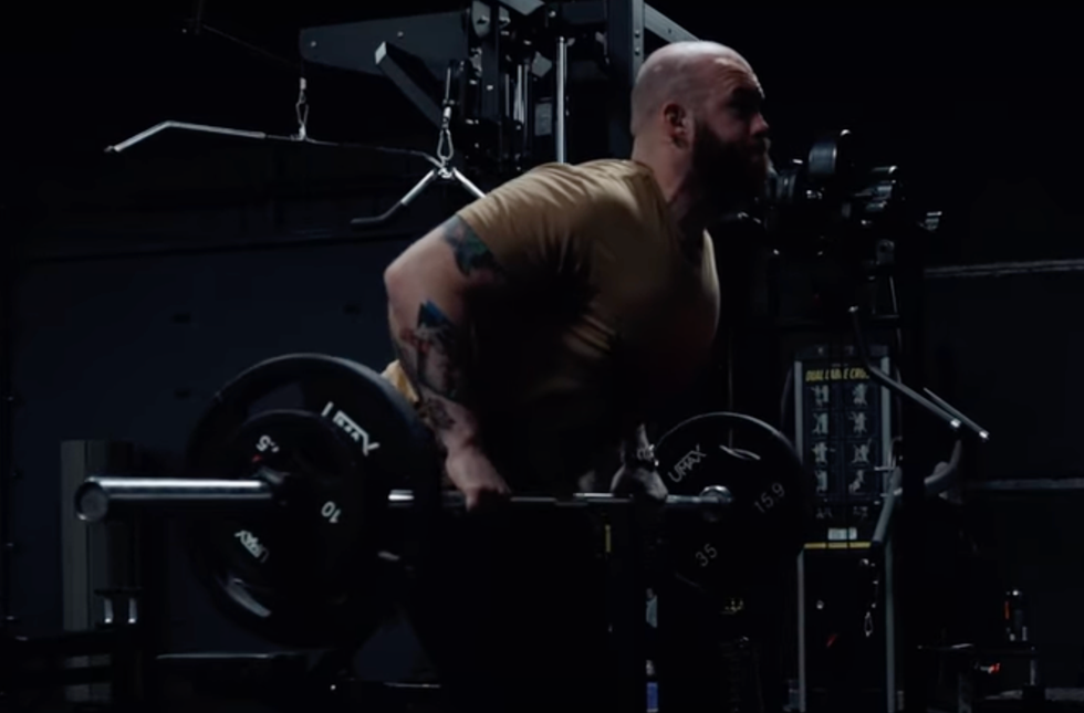 a person performing a deadlift exercise in a gym