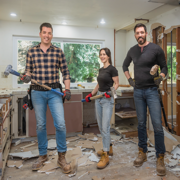 three individuals in a construction zone with tools for demolition three individuals in a construction zone with tools for demolition