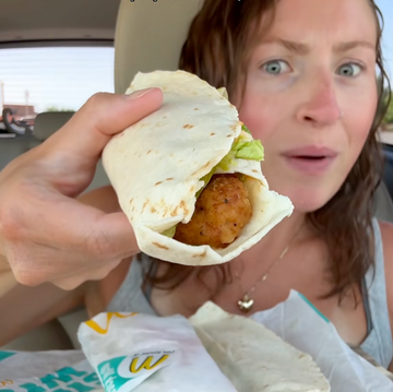 woman holding snack wrap to camera woman holding snack wrap to camera