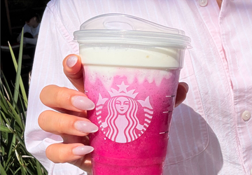 a colorful beverage from a wellknown coffee shop is being held