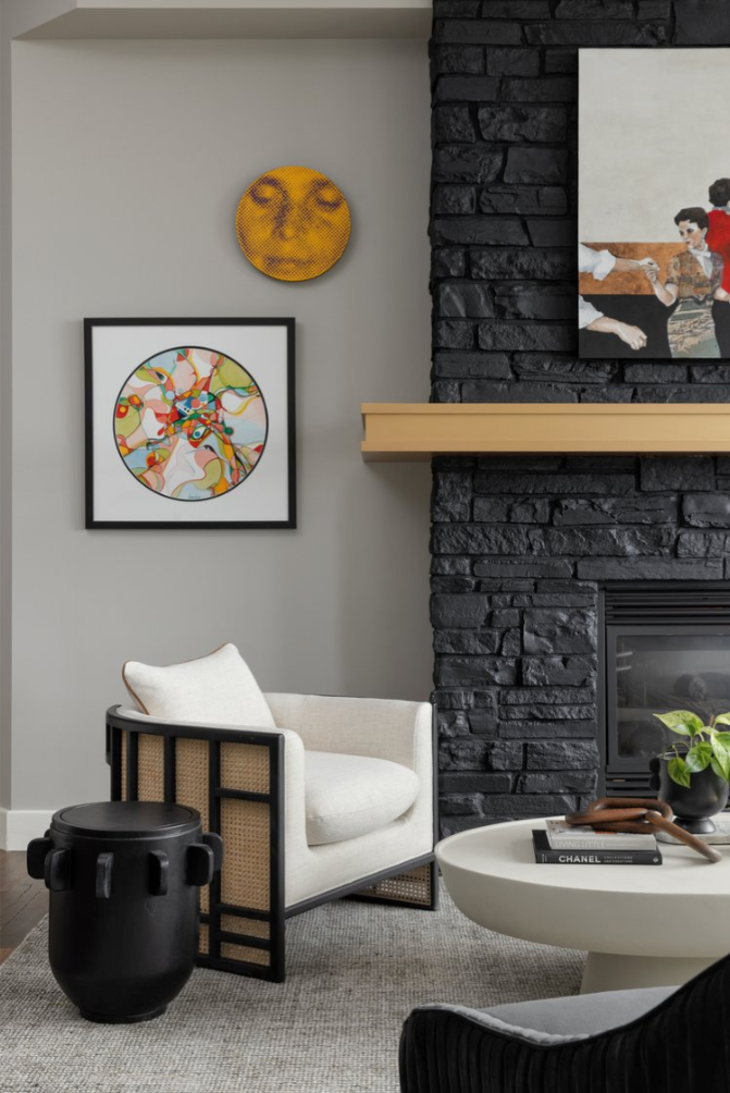 living room with modern decor featuring an armchair artwork and a fireplace