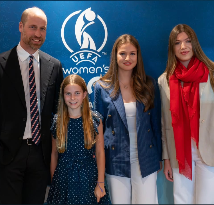 group of people posing in front of a uefa womens football event backdrop
